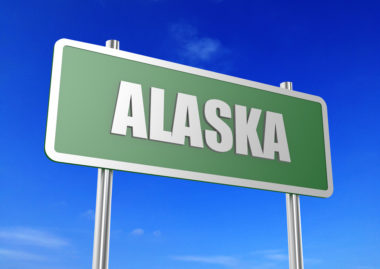 A graphic of a road sign that reads "Alaska."