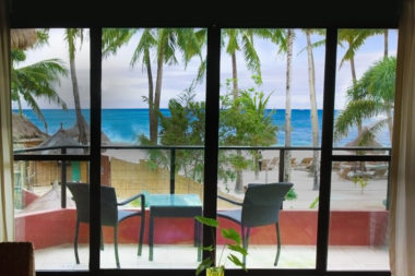 A tropical window view from the inside of a timeshare.
