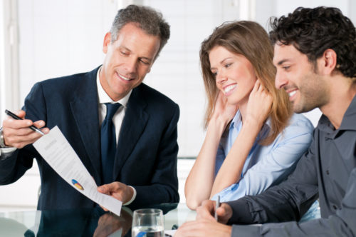 A couple speaking to a financial advisor about banking.