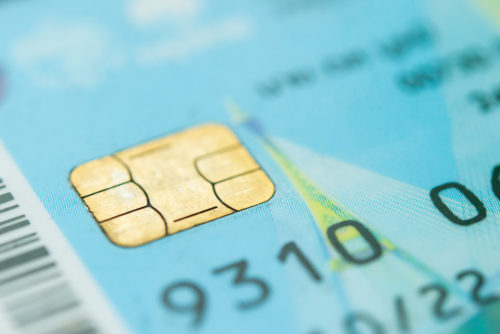 A close up of the EMV chip on a credit card.