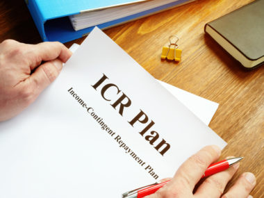 A man holding a document labeled "ICR Plan: Income-contingent repayment plan."
