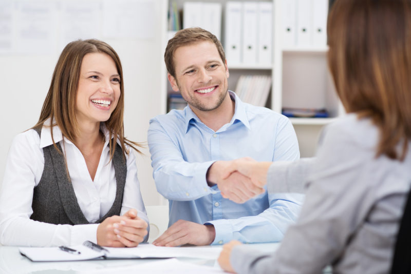 A couple speaking to a bank representative.