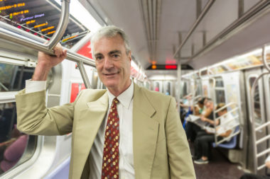 A retired man riding the subway in New York.