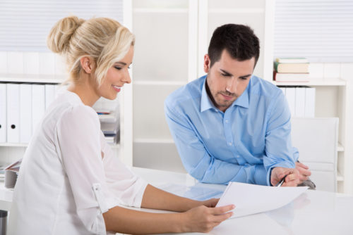 A bank representative speaking to a potential customer.