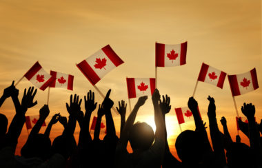 A group of people waving the Canadian flag.