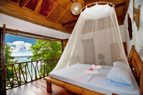 A honeymoon suite with a tropical view in an exotic location.