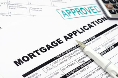 A mortgage application sits under a pen.