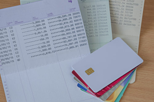 Credit cards sitting on top of their statements.