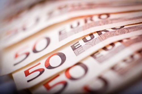 Euro bills stacked on top of each other.