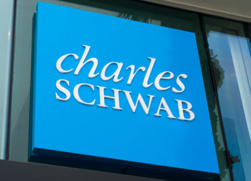 An image of a Charles Schwab sign outside of a brokerage branch.