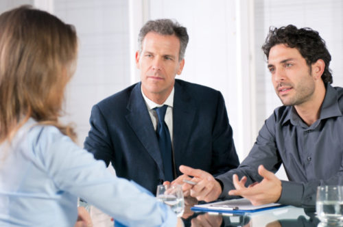 A banker speaking with some clients.