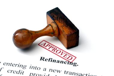 A refinancing contract is stamped "approved."