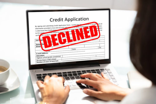 A person viewing a credit card application site, finding that their application has been denied.