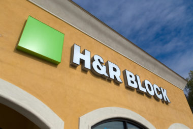 The exterior of a building displays an "H&R Block" sign.