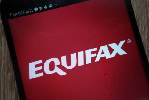A smartphone displays the Equifax logo.