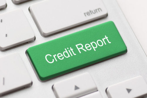 A green button on a computer keyboard reads "credit report."