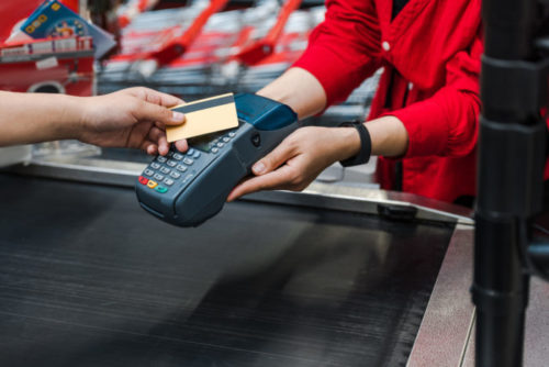 A customer paying with their credit card at a supermarket.