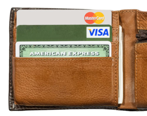 An American Express credit card stands out among others in a leather wallet.