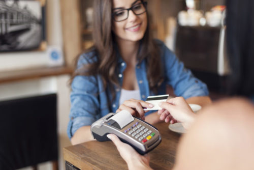 A woman making a purchase with her credit card.