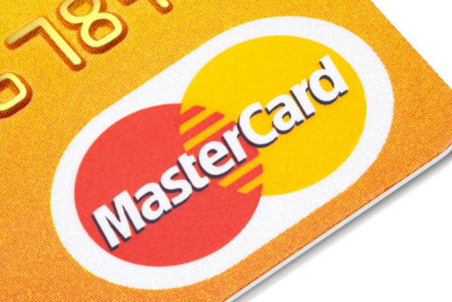 A closeup of the corner of a credit card reveals the MasterCard logo.