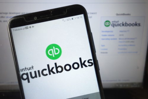 Both a phone and a computer screen display the QuickBooks website.