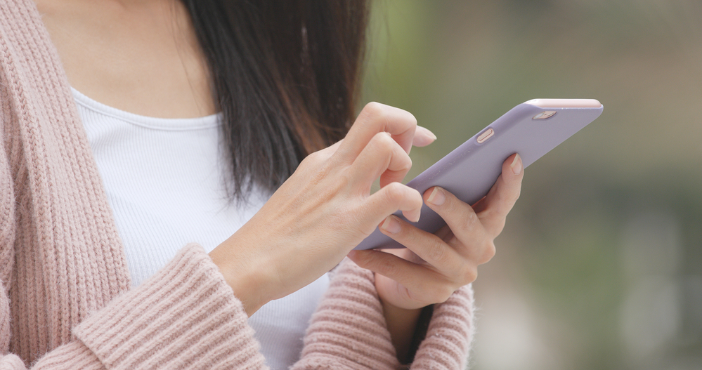 A closeup of a person checking their phone.