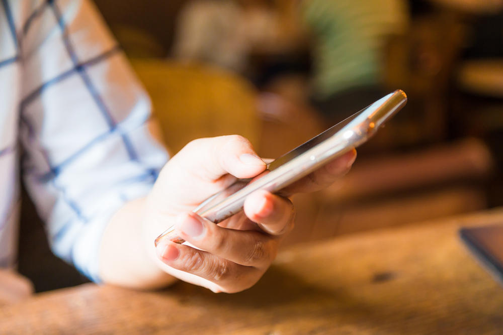 A closeup of a person using their phone.