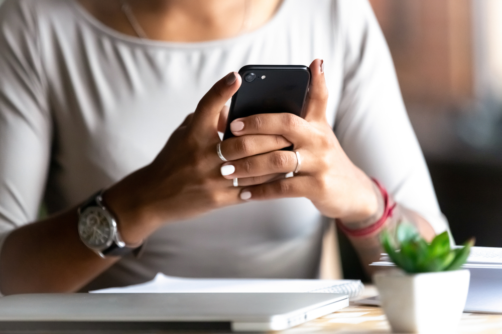 A closeup of a person using their phone.