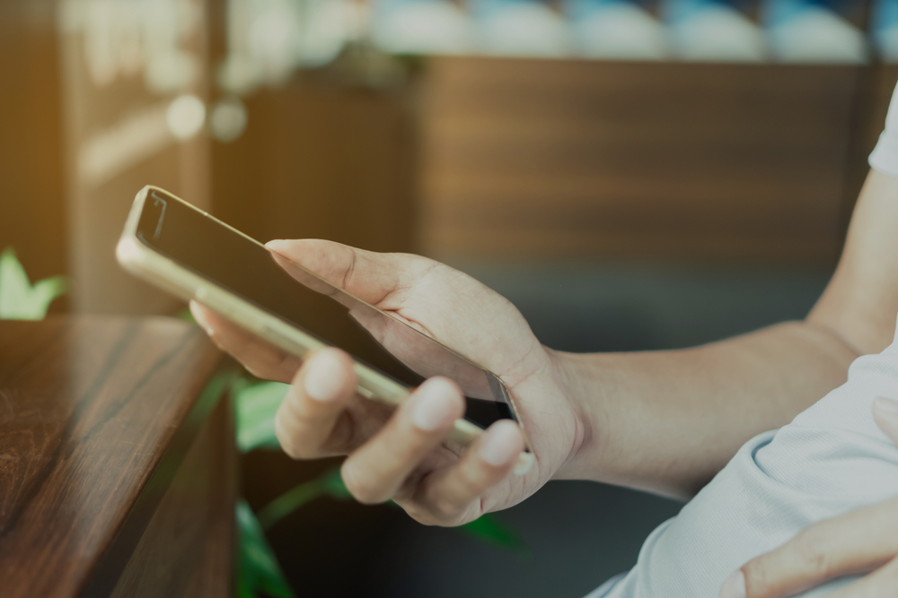 A closeup of a person using their phone.