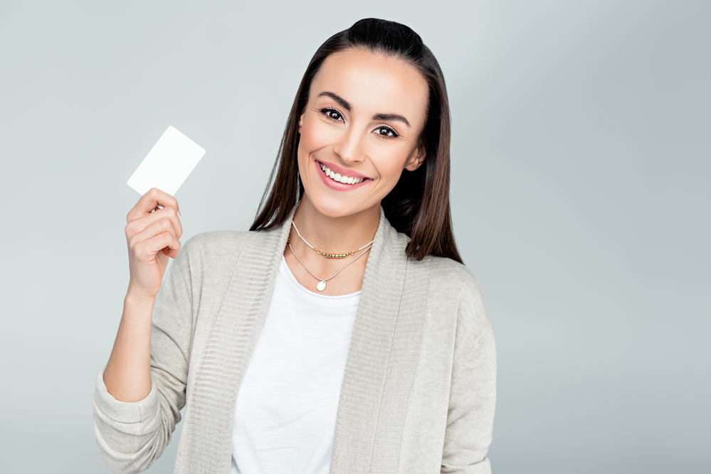 A person holding a credit card for the camera.