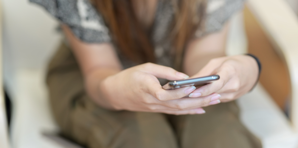 A closeup of a person using their phone.