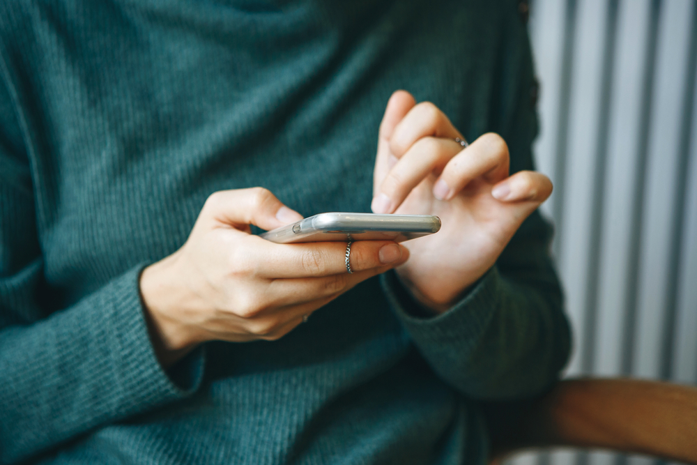 A closeup of a person using their phone.