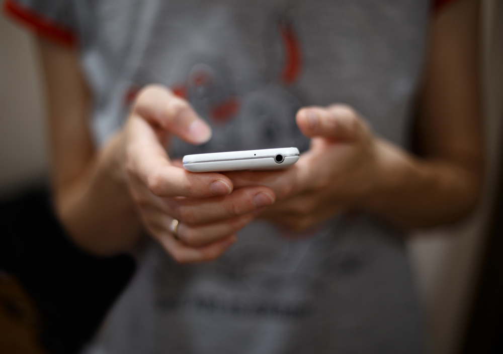 A closeup of a person using their phone.