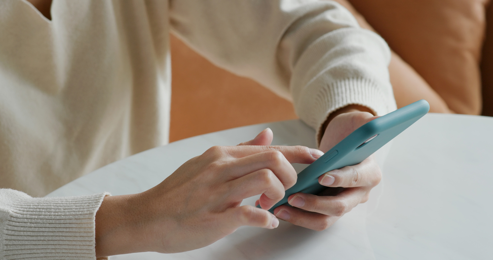 A closeup of a person using their phone.