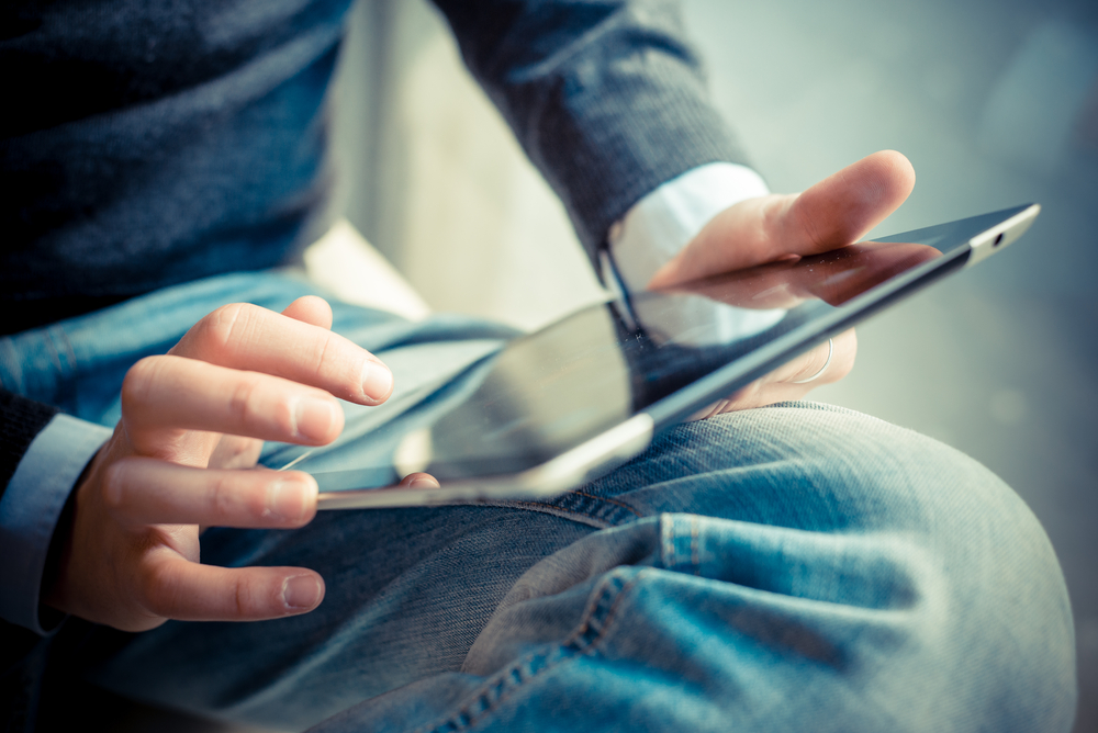 A closeup of a person using a tablet.