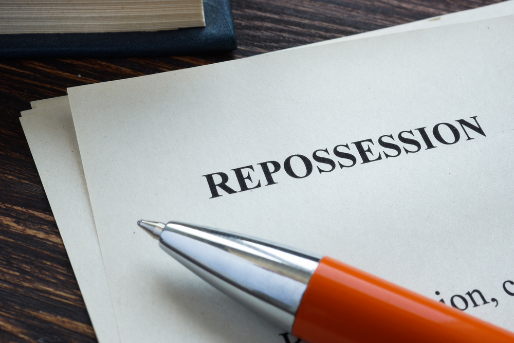 A pen sits on top of a document labeled "repossession."