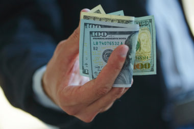 A businessperson holding money.