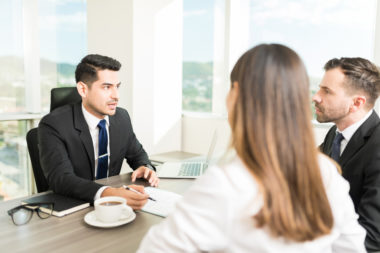 A couple meeting with a debt relief representative.