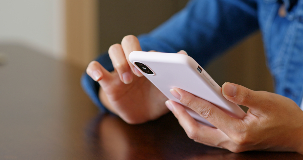 A closeup of a person using their phone.