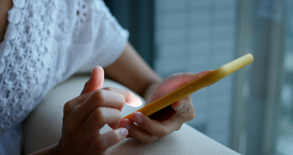 A closeup of a person using their phone.