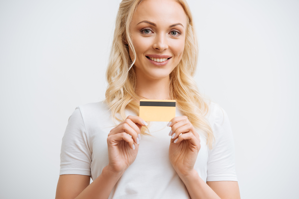 A person holding their credit card.