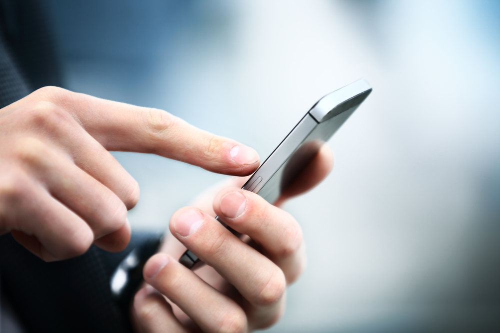 A closeup of a person using their phone.