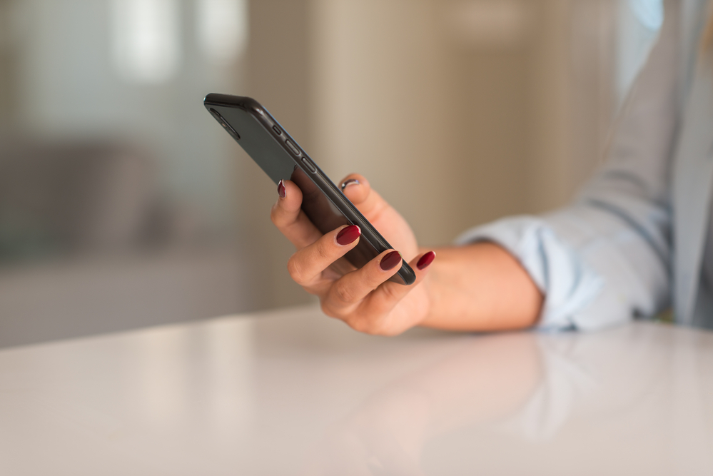 A closeup of a person holding a phone.