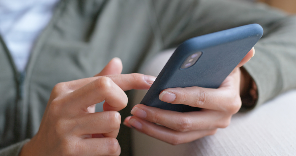 A closeup of a person using their phone.