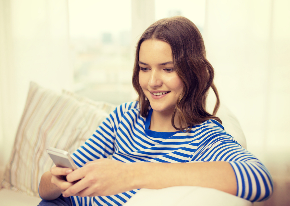 A person sitting on a couch using their phone.