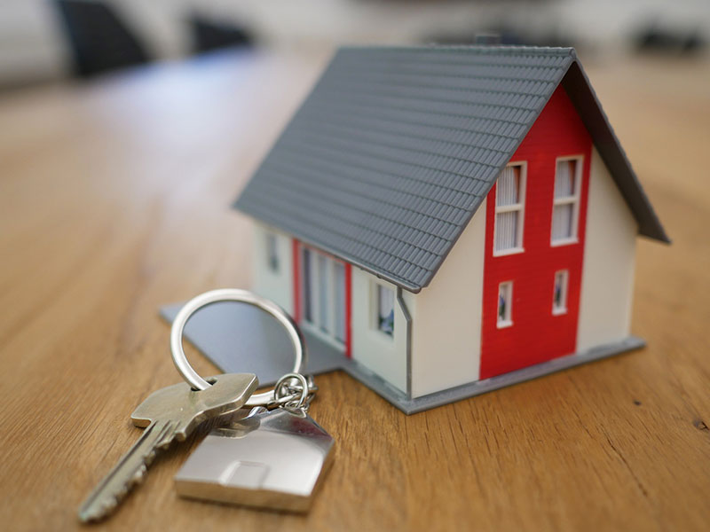 toy house and a key on a table