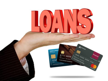 hand holding the texts loans and credit cards