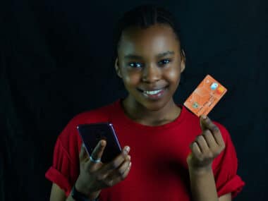 a kid holding credit card in her hand